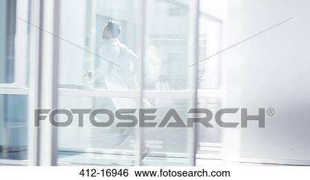 Doctor running in hospital corridor View Large Photo Image Stock Photograph - Doctor running in hospital corridor. Fotosearch