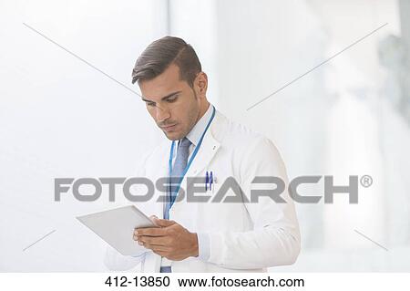 Stock Image - Doctor using digital tablet. Fotosearch