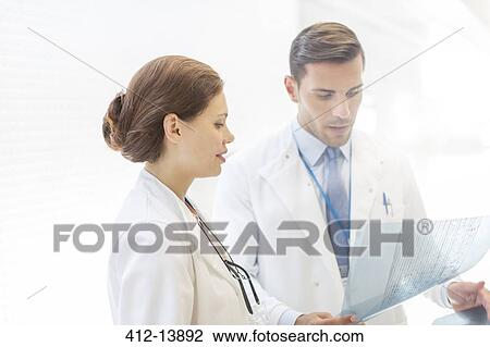 Doctors examining transparency View Large Photo Image Stock Image - Doctors examining transparency. Fotosearch