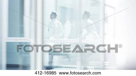 Doctors running in hospital corridor View Large Photo Image Stock Photography - Doctors running in hospital corridor. Fotosearch