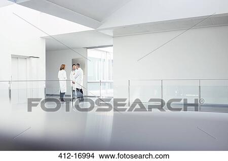 Doctors talking in hospital corridor View Large Photo Image Picture - Doctors talking in hospital corridor. Fotosearch