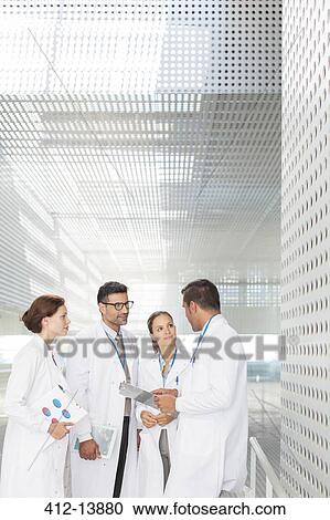 Doctors talking in hospital corridor View Large Photo Image Stock Image - Doctors talking in hospital corridor. Fotosearch