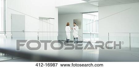 Doctors talking in hospital corridor View Large Photo Image Stock Photo - Doctors talking in hospital corridor. Fotosearch