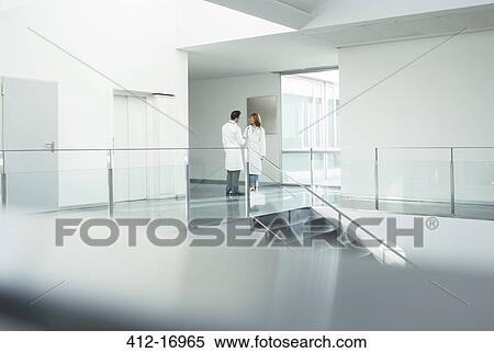 Stock Photography - Doctors talking in hospital corridor. Fotosearch