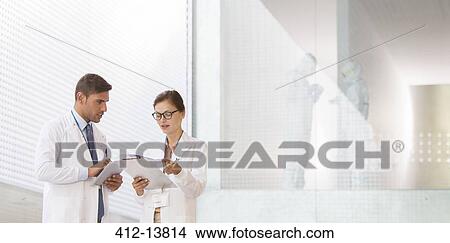 Picture - Doctors talking in hospital. Fotosearch