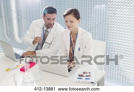 Doctors working at laptop View Large Photo Image Stock Image - Doctors working at laptop. Fotosearch
