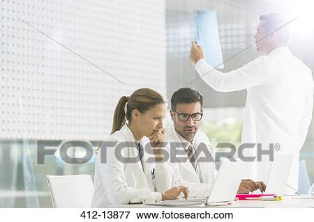 Doctors working in hospital View Large Photo Image Stock Photo - Doctors working in hospital. Fotosearch