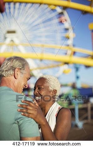 Stock Photo - Enthusiastic senior couple at amusement park. Fotosearch