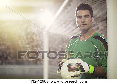 Goalie holding ball in soccer net View Large Photo Image Stock Photo - Goalie holding ball in soccer net. Fotosearch