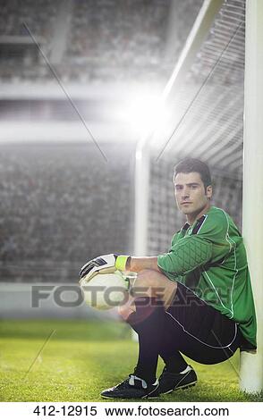 Goalie holding soccer ball by net View Large Photo Image Stock Photography - Goalie holding soccer ball by net. Fotosearch