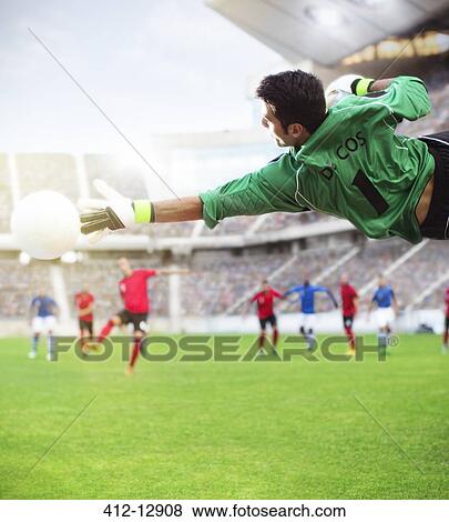 Goalie reaching for ball in mid-air on soccer field View Large Photo Image Stock Photo - Goalie reaching for ball in mid-air on soccer field. Fotosearch