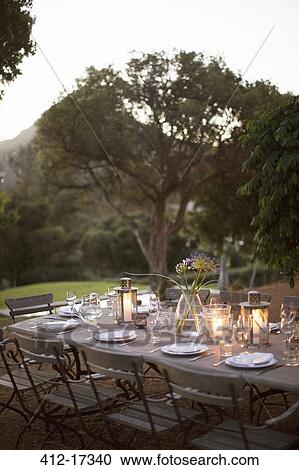 Illuminated lanterns on tranquil patio table View Large Photo Image Stock Image - Illuminated lanterns on tranquil patio table. Fotosearch