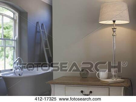 Lamp on bedside table View Large Photo Image Stock Photography - Lamp on bedside table. Fotosearch