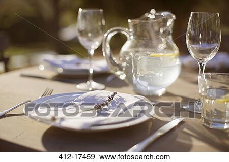 Lavender sprig on plate on sunny patio table View Large Photo Image Stock Photo - Lavender sprig on plate on sunny patio table. Fotosearch