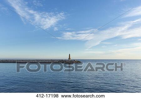 Stock Photo - Lighthouse on jetty. Fotosearch