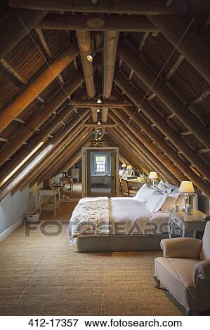 Stock Photo - Luxury attic bedroom. Fotosearch