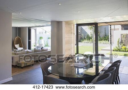 Luxury dining room open to sunny patio View Large Photo Image Stock Image - Luxury dining room open to sunny patio. Fotosearch