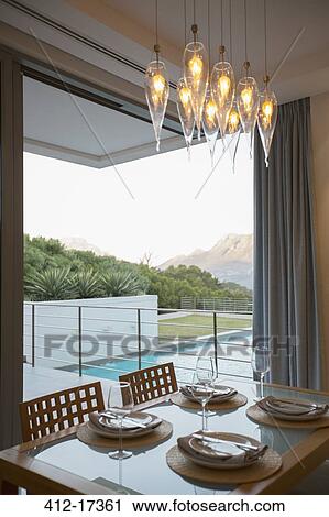 Luxury dining room overlooking balcony and swimming pool View Large Photo Image Stock Image - Luxury dining room overlooking balcony and swimming pool. Fotosearch