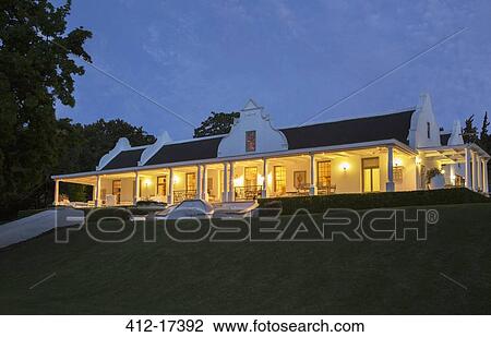 Luxury house and porch illuminated at night View Large Photo Image Stock Image - Luxury house and porch illuminated at night. Fotosearch