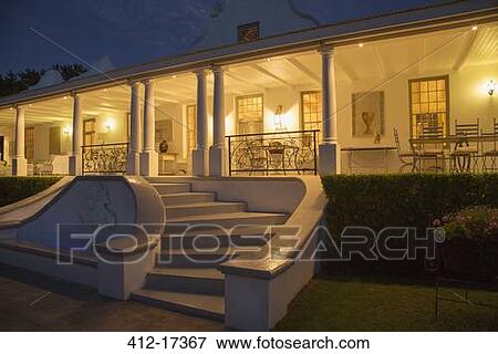 Luxury house with porch illuminated at night View Large Photo Image Stock Photo - Luxury house with porch illuminated at night. Fotosearch