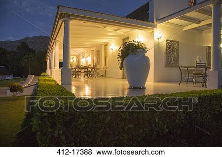 Luxury house with porch illuminated at night View Large Photo Image Stock Photo - Luxury house with porch illuminated at night. Fotosearch