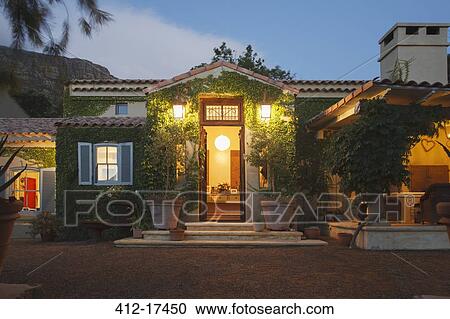 Stock Image - Luxury villa illuminated at night. Fotosearch