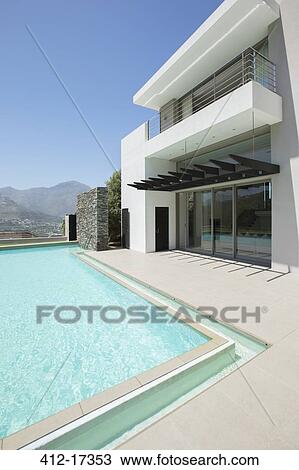 Modern house and swimming pool View Large Photo Image Stock Image - Modern house and swimming pool. Fotosearch