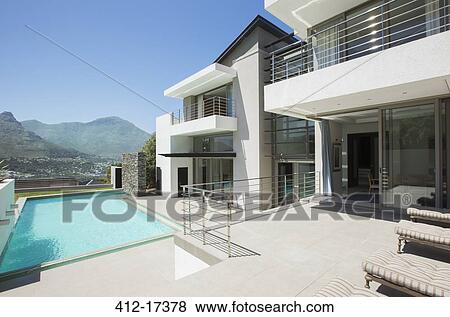Modern house and swimming pool View Large Photo Image Stock Photo - Modern house and swimming pool. Fotosearch