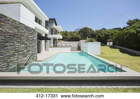 Stock Image - Modern house with swimming pool. Fotosearch