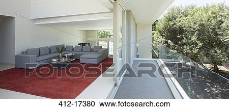 Stock Image - Modern living room open to balcony. Fotosearch