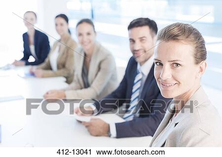 Portrait of confident business people in conference room View Large Photo Image Stock Image - Portrait of confident business people in conference room. Fotosearch