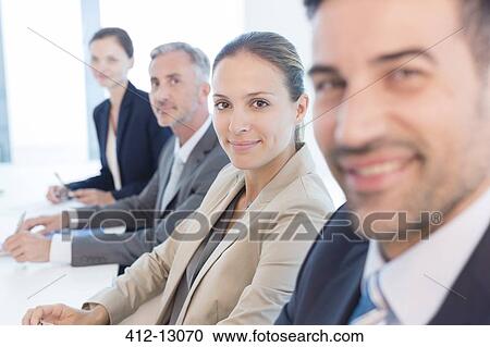Portrait of confident business people in conference room View Large Photo Image Stock Image - Portrait of confident business people in conference room. Fotosearch