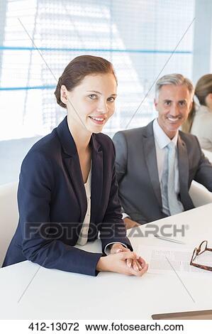 Portrait of confident business people at conference table View Large Photo Image Stock Image - Portrait of confident business people at conference table. Fotosearch