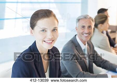 Portrait of confident business people in conference room View Large Photo Image Stock Photo - Portrait of confident business people in conference room. Fotosearch