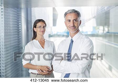 Stock Photography - Portrait of confident business people in office. Fotosearch
