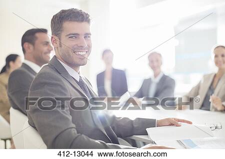 Picture - Portrait of confident businessman in conference room. Fotosearch