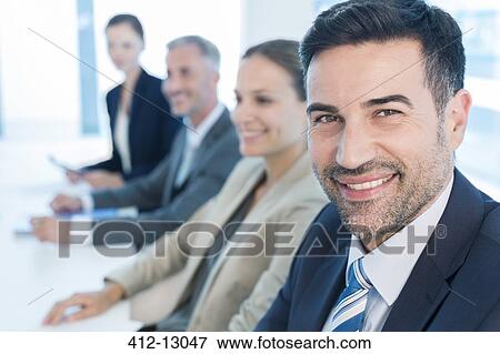 Portrait of confident businessman in conference room View Large Photo Image Stock Photo - Portrait of confident businessman in conference room. Fotosearch