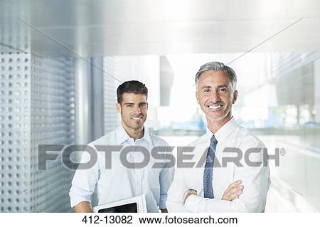Portrait of confident businessmen in office View Large Photo Image Stock Image - Portrait of confident businessmen in office. Fotosearch