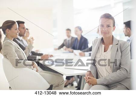 Stock Photo - Portrait of confident businesswoman in conference room. Fotosearch