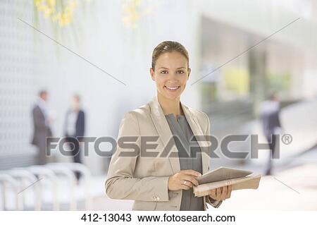 Stock Image - Portrait of confident businesswoman with digital tablet. Fotosearch