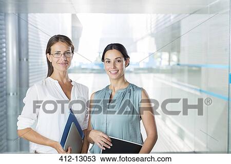 Portrait of confident businesswomen in office View Large Photo Image Stock Image - Portrait of confident businesswomen in office. Fotosearch