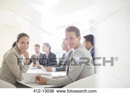 Portrait of confident businesswomen in conference room View Large Photo Image Stock Photo - Portrait of confident businesswomen in conference room. Fotosearch