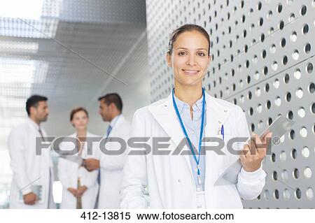 Portrait of confident doctor in hospital corridor View Large Photo Image Stock Photography - Portrait of confident doctor in hospital corridor. Fotosearch