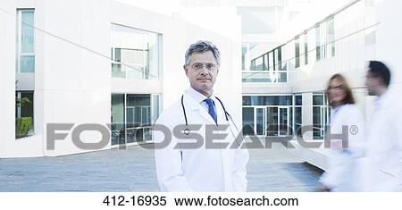 Stock Photography - Portrait of confident doctor on rooftop. Fotosearch