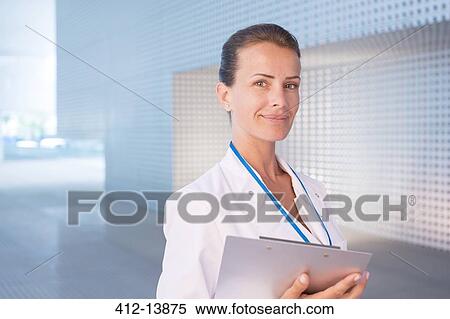 Stock Photography - Portrait of confident doctor. Fotosearch