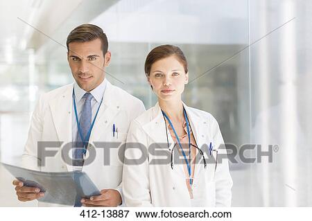 Portrait of confident doctors in hospital View Large Photo Image Stock Photo - Portrait of confident doctors in hospital. Fotosearch