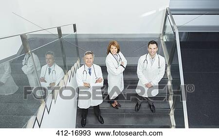 Portrait of confident doctors on stairs View Large Photo Image Stock Image - Portrait of confident doctors on stairs. Fotosearch