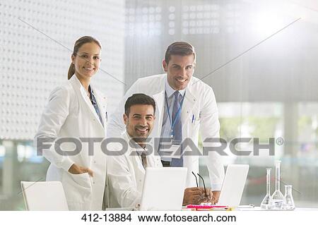 Picture - Portrait of confident doctors working at laptop. Fotosearch