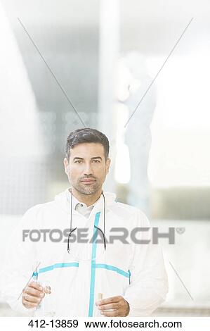 Portrait of confident scientist in clean suit in laboratory View Large Photo Image Stock Photo - Portrait of confident scientist in clean suit in laboratory. Fotosearch
