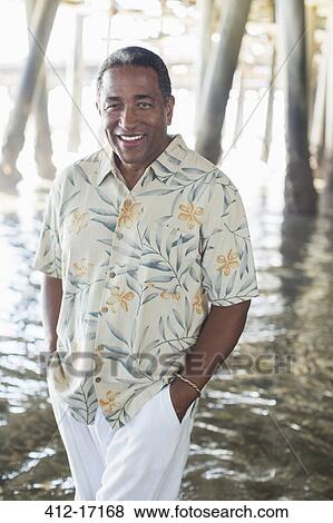 Portrait of confident senior man under pier at beach View Large Photo Image Stock Photo - Portrait of confident senior man under pier at beach. Fotosearch